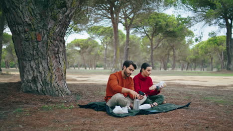 young couple autumn picnic in park at blanket vertical. family romantic weekend