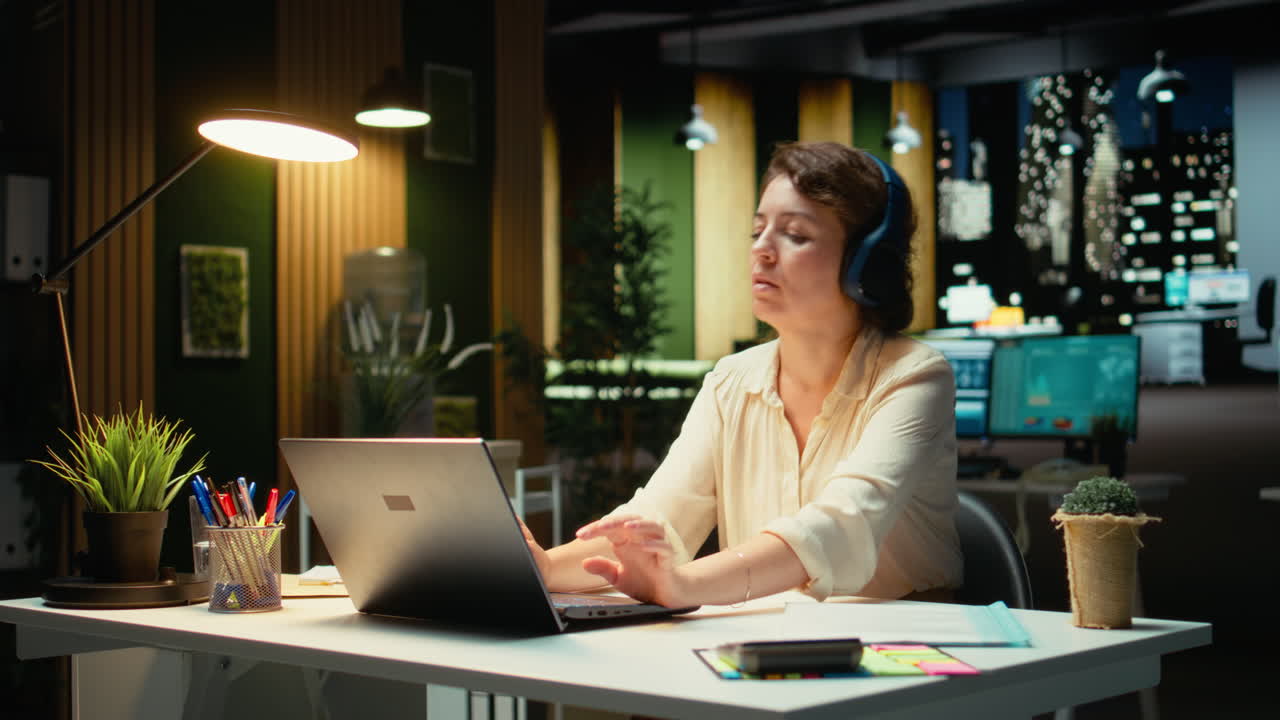 Vertical Video Employee working on tasks with focus music and stretching her muscles
