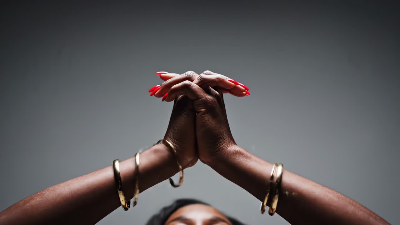 Woman with red nails and gold bracelets