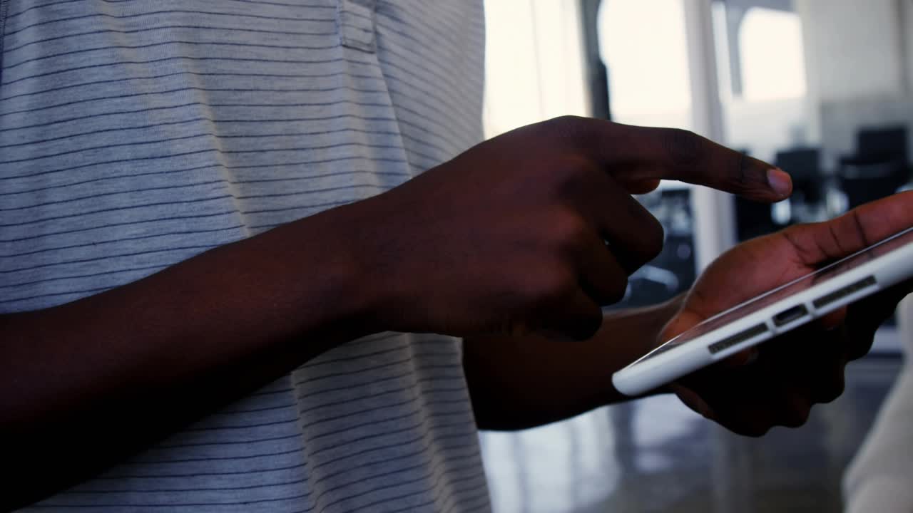 Man using tablet, hovering, tapping screen in business, analyzing data as overlays forming blue bar
