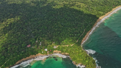 Bocas-del-Toro-Panama-Aerial-v10-cinematic-flyover-paunch-peninsula,-tilt-up-reveals-coastal-view-of-bluff-beach-with-turquoise-blue-seascape-and-tropical-forest---Shot-with-Mavic-3-Cine---April-2022