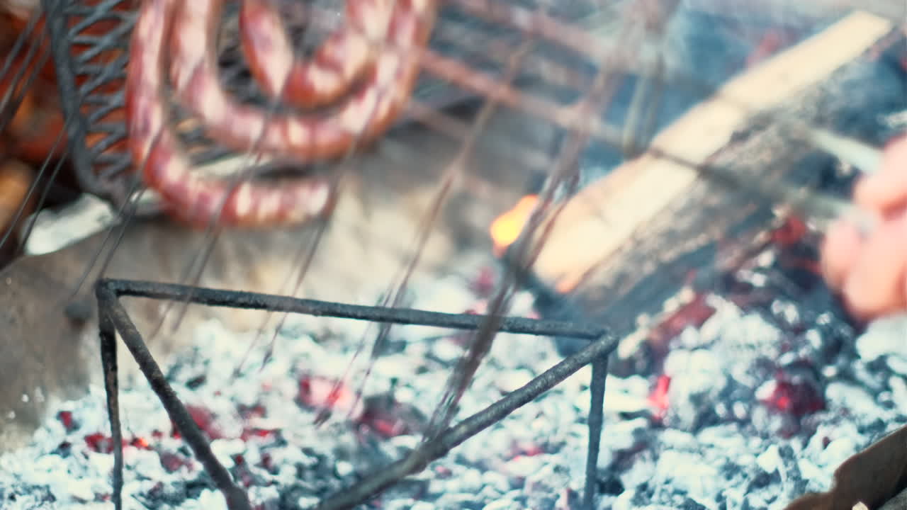 South African traditional boerewors on grid being barbecued on hot wood fire