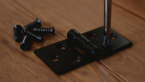 close up of screws screwed into wood with a screwdriver