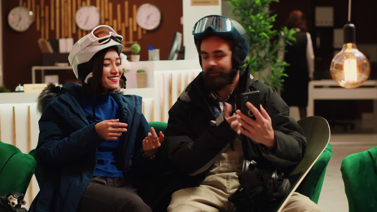 Travellers answer videocall at hotel