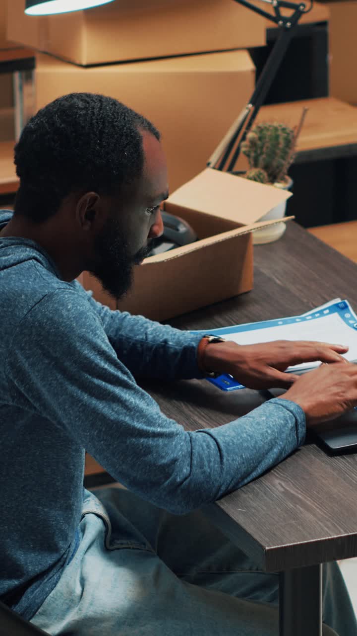 Vertical video: Young adult analyzing supply chain and logistics to work on distribution