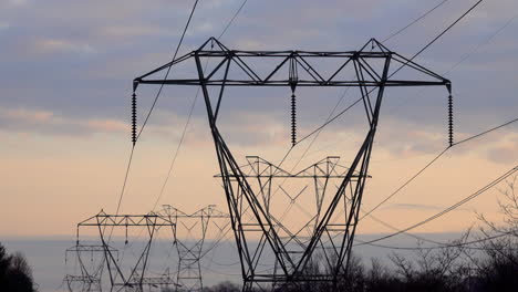 Long-line-of-electrical-towers-at-sunset