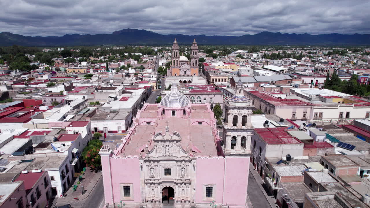 Drone footage moving from the front of the Jerez's parish to the sanctuary, showcasing bell towers and architecture