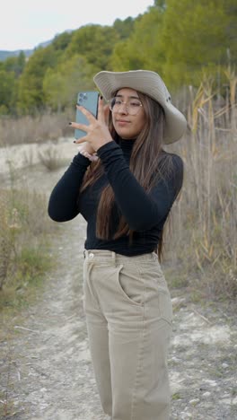 woman capturing nature's beauty and scenic lake landscape