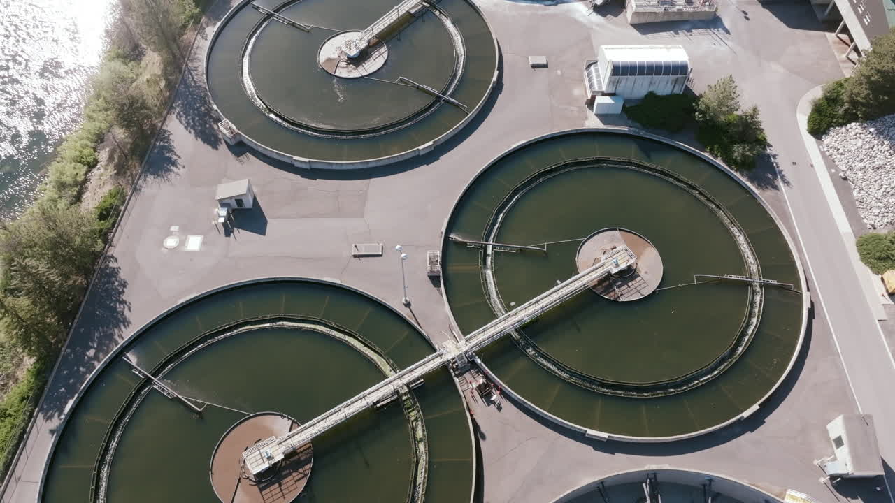 Overhead aerial view of large circular clarifier tanks at a water treatment facility in Spokane, Washington, with visible machinery and infrastructure used for sedimentation and filtration