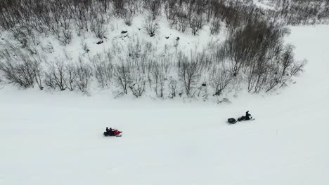 snowmobiling in a snowy winter landscape