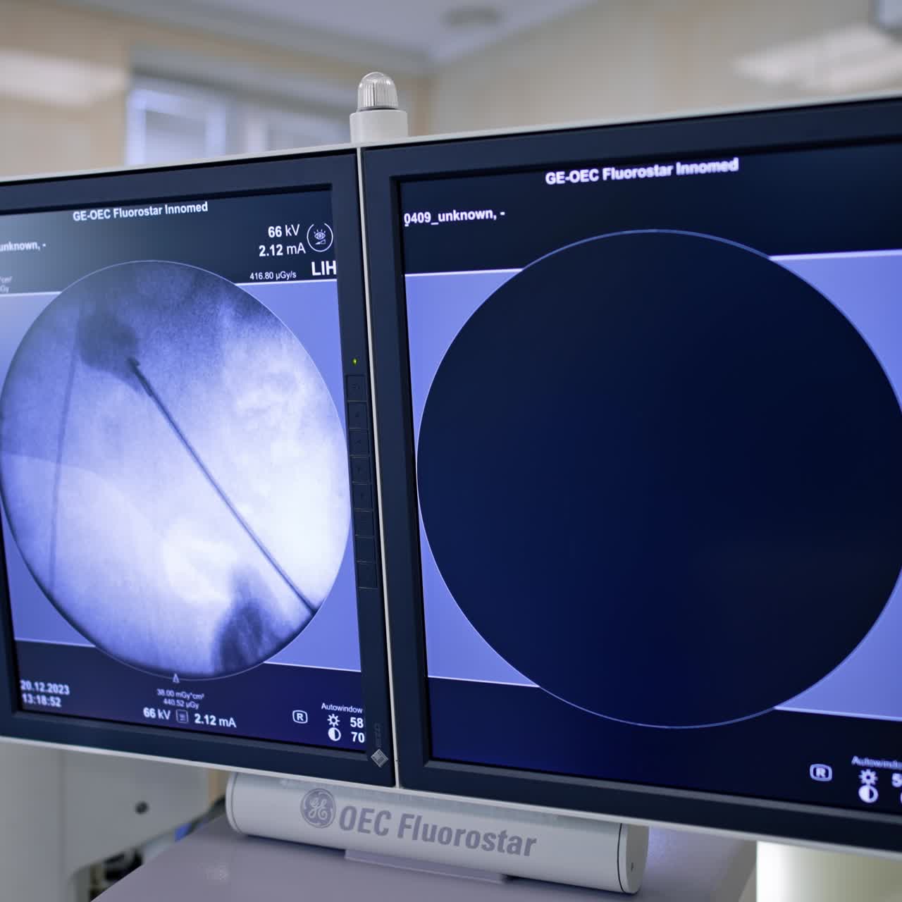 Monitor of C-arm x-ray apparatus displaying the operational spot with a tool input. Modern medical equipment being used at endoscopic surgeries