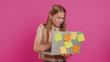 exhausted freelancer woman with pasted sticker notes use laptop confused by big routine work loading