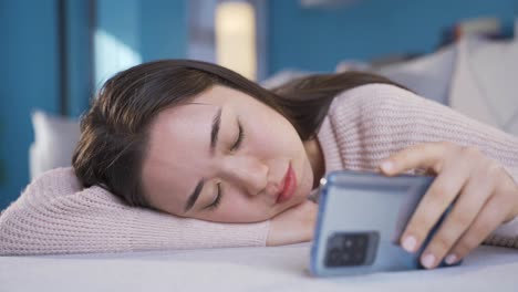 young asian woman looking at phone, spending time.