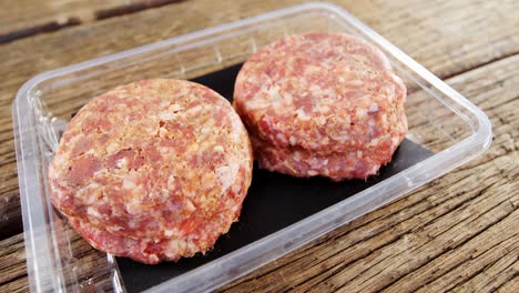 meat patty in plastic container