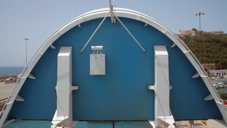 Front-part-lifting-up-of-a-car-transportation-ferry-shot-from-the-boat