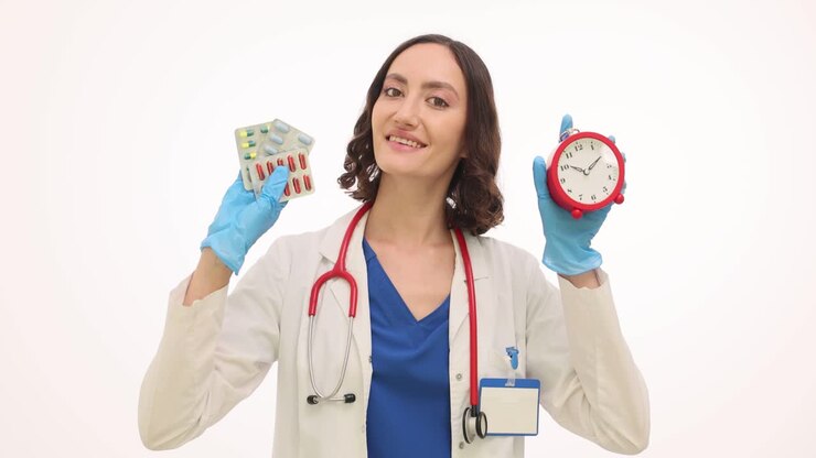 Female Doctor Holding Alarm Clock and Medication