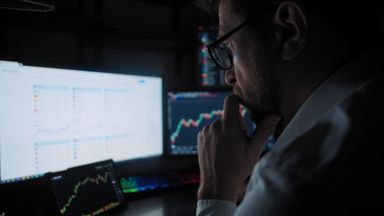 Male trader analyzes the stock market