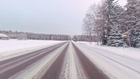 speedy winter commute on icy road pov drive on rural forest highway finland