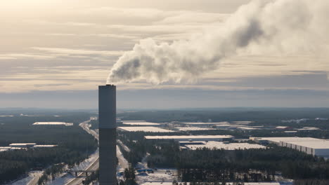 Drone-arc-around-factory-smokestack-venting-hazardous-greenhouse-gas-emissions