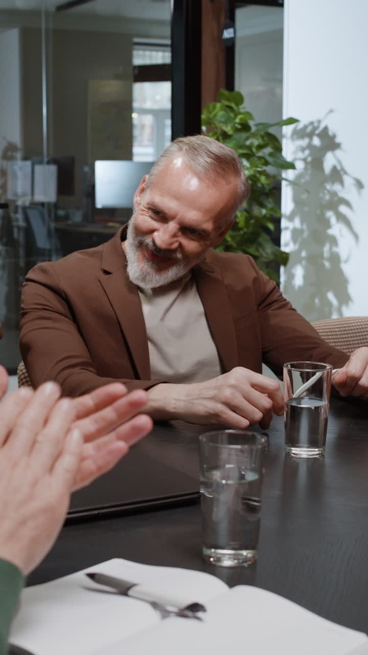 Smiling Senior Businessman Engaged in an Office Meeting