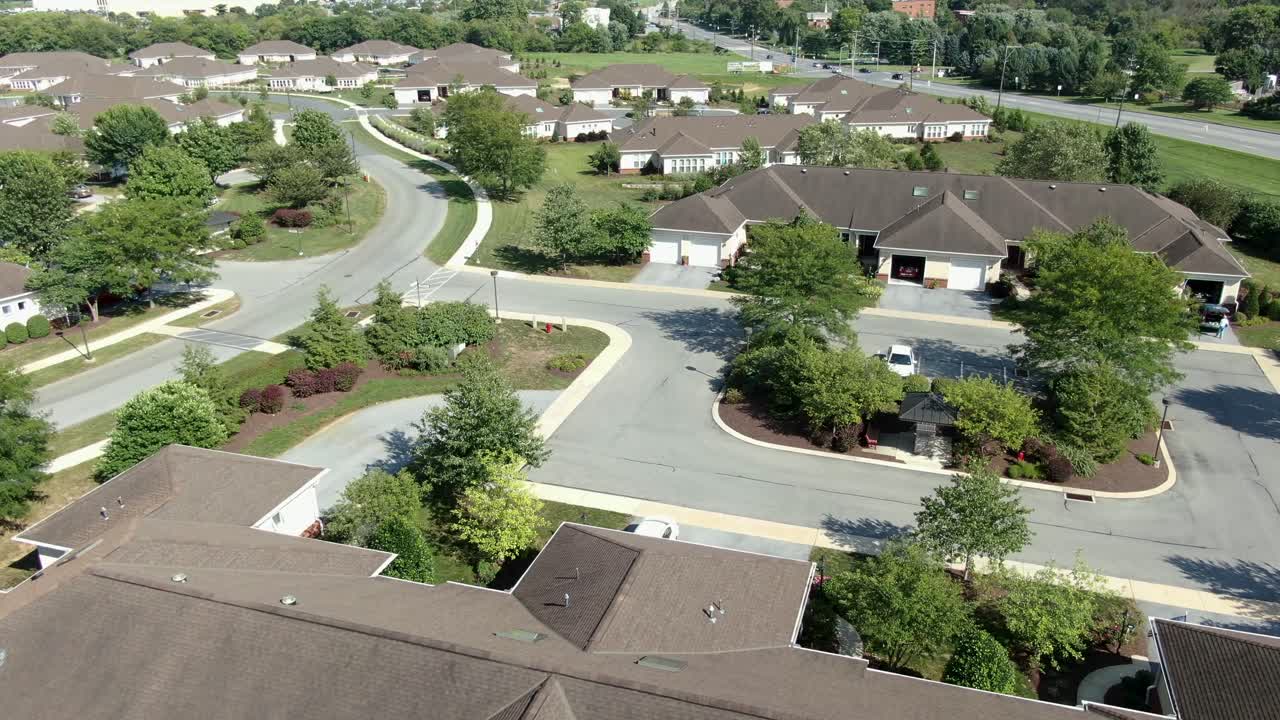 Rising aerial of single-story independent living in retirement village in USA, summer view of residential retiree neighborhood community