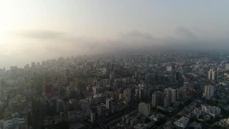 Aerial-view-of-the-cityscape-of-Lima,-dramatic,-foggy-evening-in-Peru