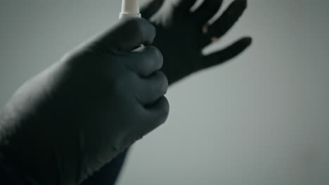 hands shaking paint bottle for permanent makeup closeup. tattooist preparing ink