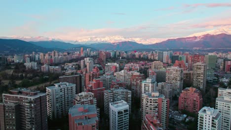 Aerial-Cityscape-Above-El-Golf-Neighborhood-in-Santiago-Chile,-El-Plomo-Mountain-Background,-Andean-Cordillera-City,-Establishing-Shot-at-Daylight