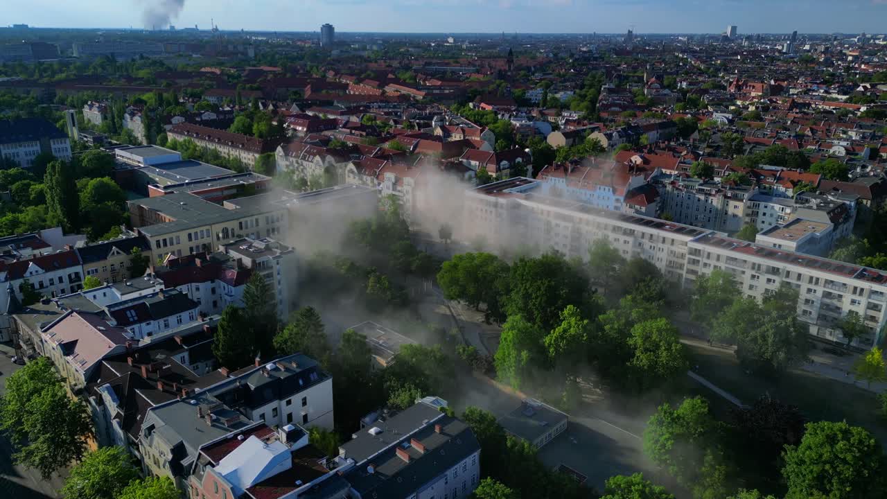 Yellow rescue helicopter landing in a Berlin urban park during a smoky emergency. Nice aerial view flight ascending drone