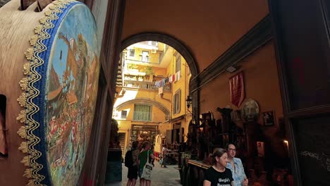 tourists browse trinkets in a vibrant naples alley