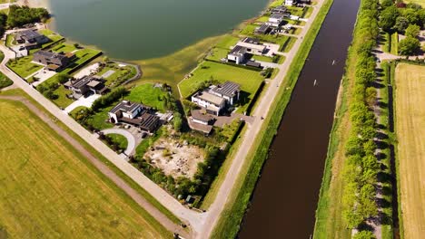 aerial view of modern houses by a canal and lake