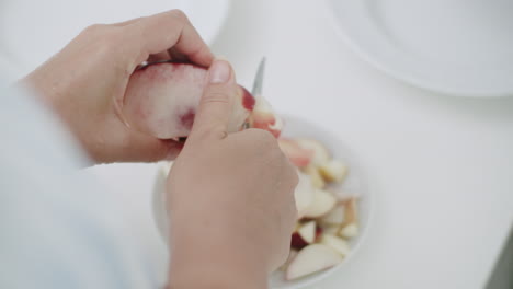 woman serving fresh fruit for breakfast