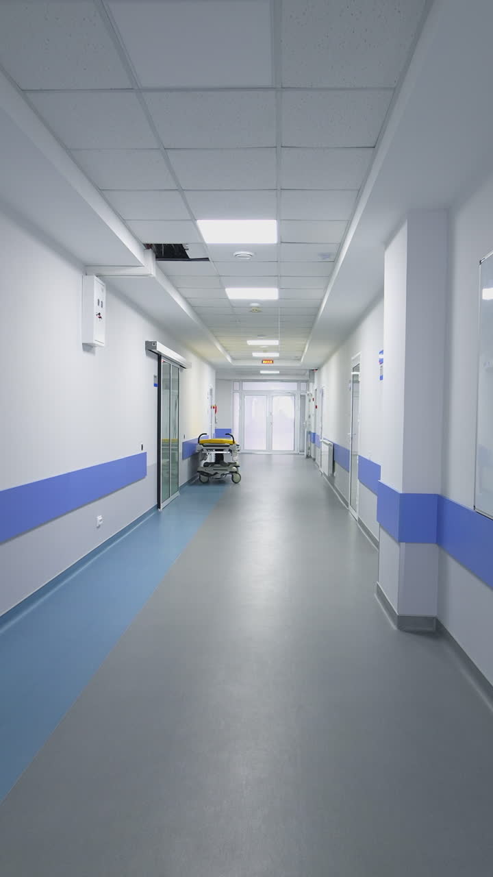 Empty Corridor In Modern Hospital. Long corridor in hospital with doors and reflections