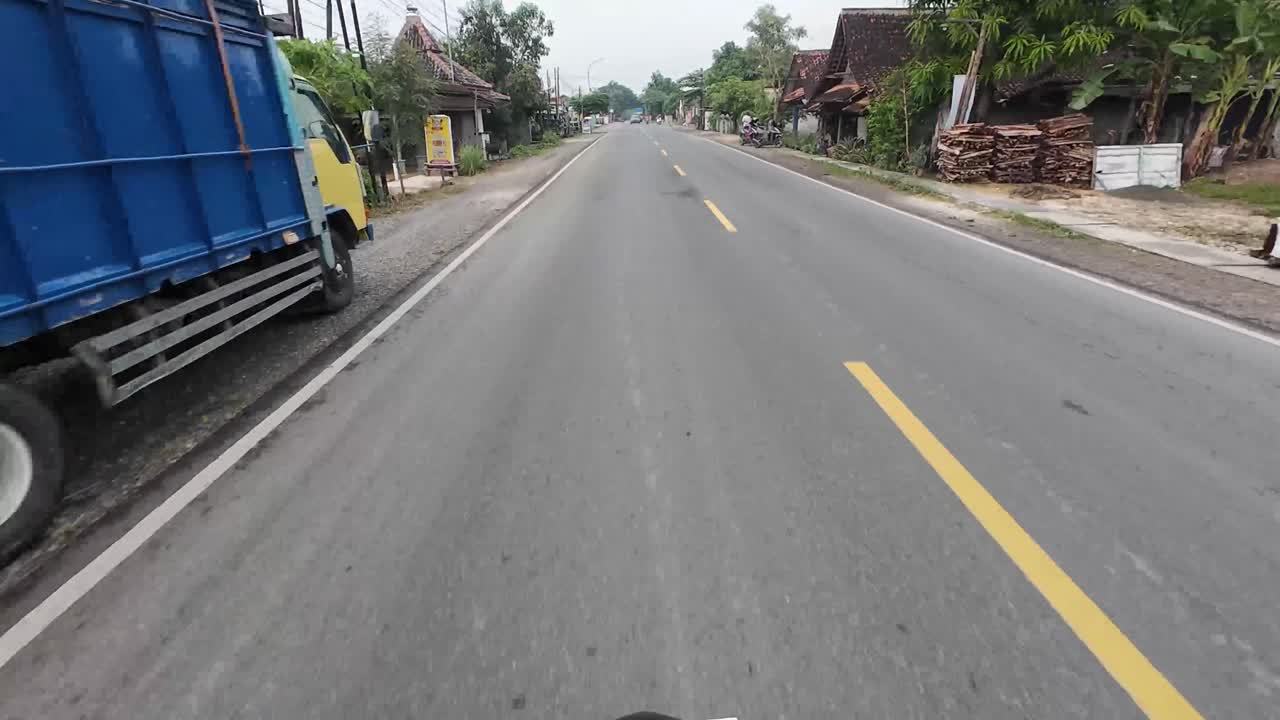 Road scenery through small town in the district of Blora, Indonesia