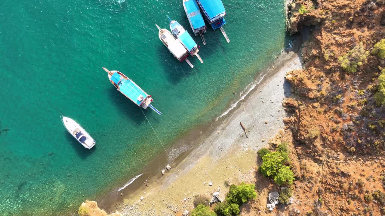 Aerial view of a beautiful beach and boats in turquoise water