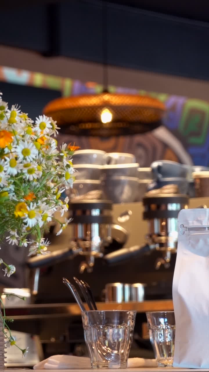 Chamomile flowers on a table at a cafe. Vertical