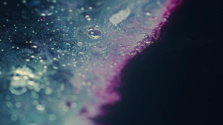 Primi piani macro colorati e organici di liquidi che vibrano e scorrono.