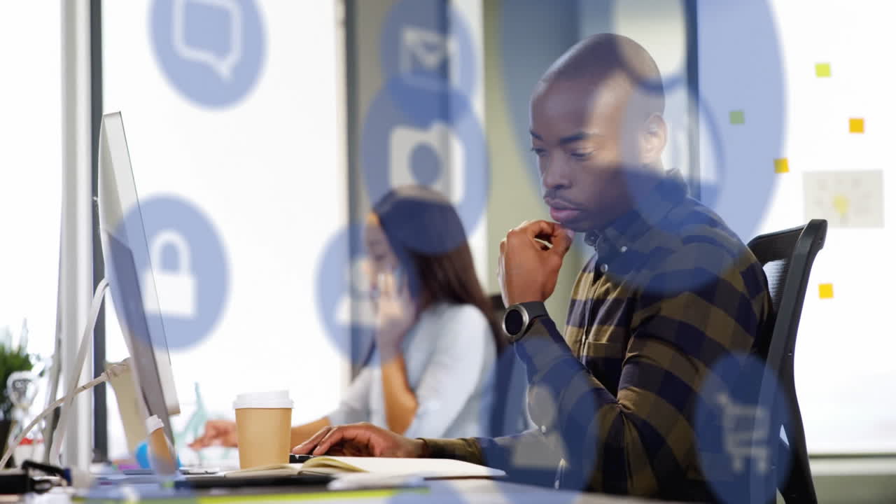 Animation of media icons over diverse colleagues working in office