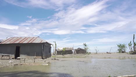 wide view of a riverside house with a swamp after the flood.