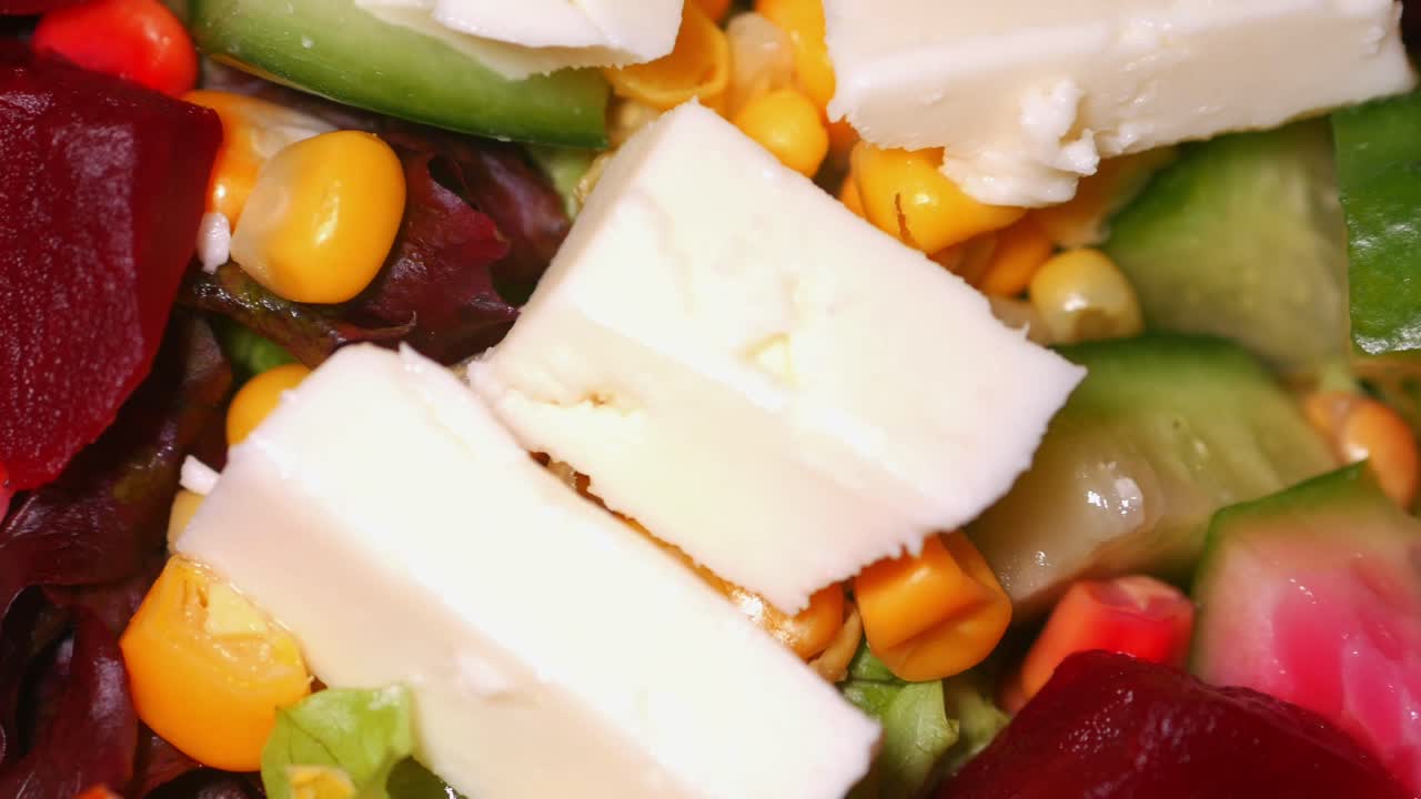 Fresh salad with feta cheese, corn, cucumber, and beetroot