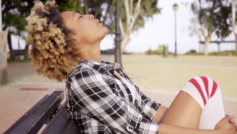 Contented-woman-with-eyes-closed-at-park