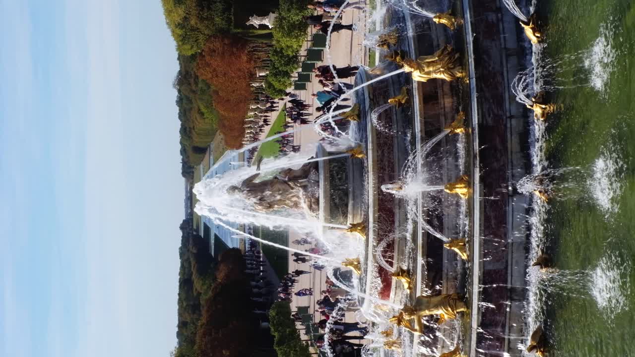 Versailles, France - April 21, 2021: View of a water fountain in the Park of Versailles. Vertical