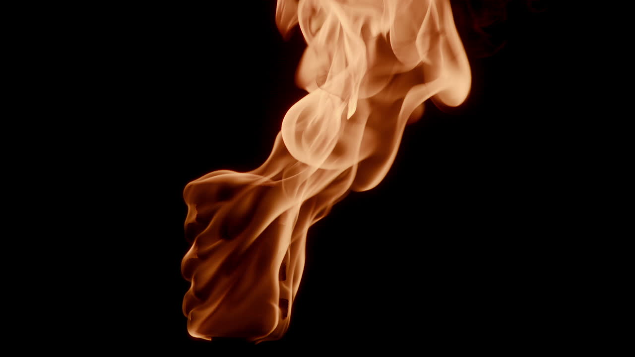 Burning fire flame torch with isolated black background - close up shot
