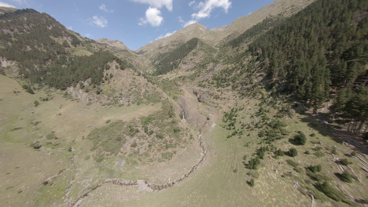 Fast FPV aerial view across Esterri D'aneu alpine woodland valley in Catalonia mountains, Spain