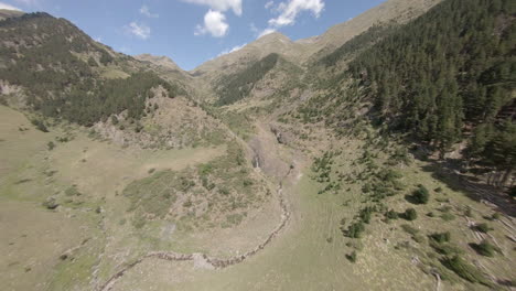 fast fpv aerial view across esterri d'aneu alpine woodland valley in catalonia mountains, spain