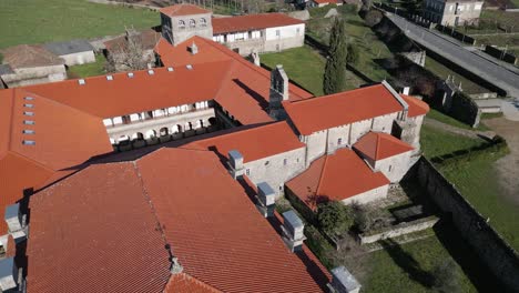 Drone-orbits-around-old-bell-tower-and-chimney-buildings-of-monastery-in-Spain