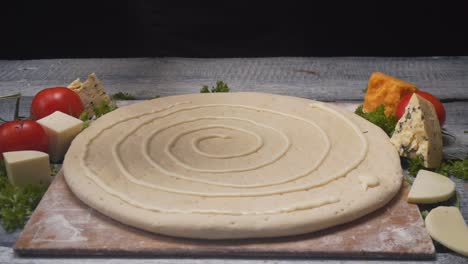 preparing a pizza with sauce