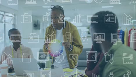 animation of multiple icons over diverse man showing color swatch to coworkers in meeting at office