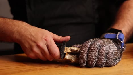 preparing oysters with metal mesh gloves