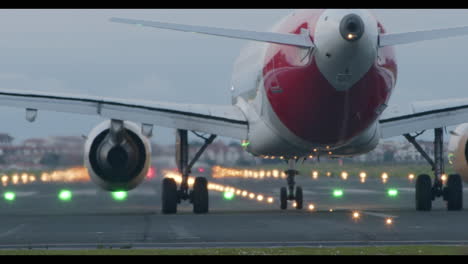 aterrizaje de un avión en la pista de aterrizo por la noche